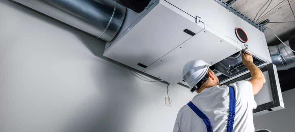 HVAC technician working on commercial ductwork