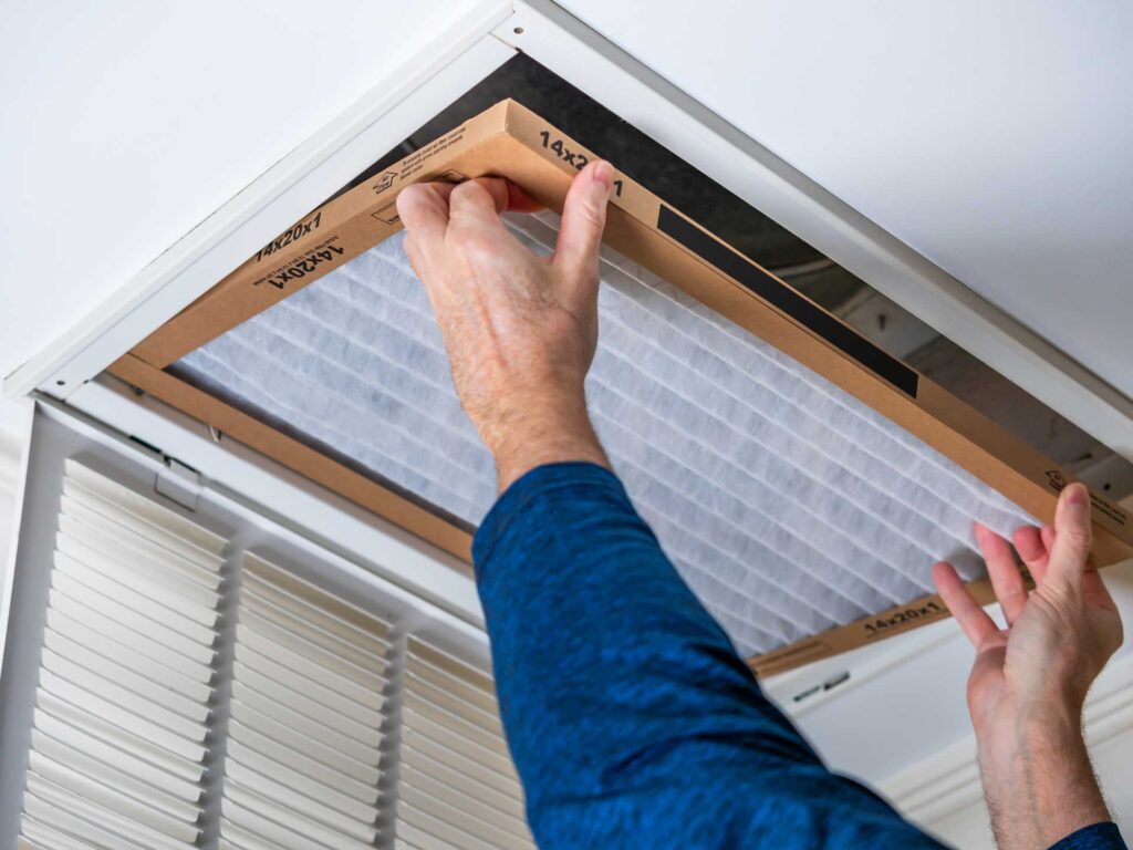 HVAC technician replacing a filter